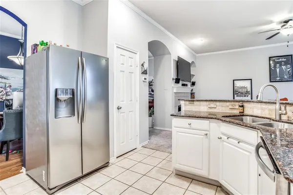 a kitchen with stainless steel appliances a refrigerator sink and cabinets