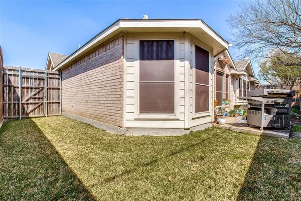 a view of outdoor space with sliding door and wooden fence