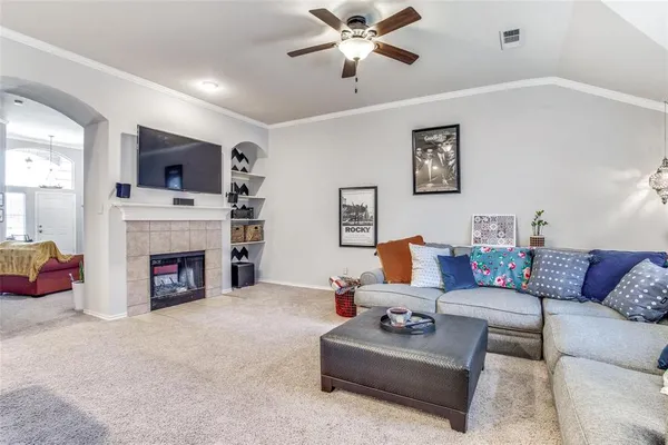 a living room with furniture a flat screen tv and a fireplace