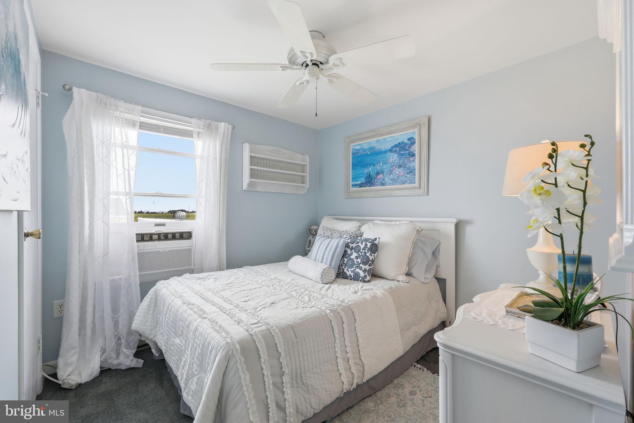 173 Cove Road Newport, NJ 08345 - Photo 28 of 72 a bedroom with a bed and a chandelier