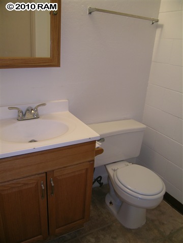111 Kahului Beach Road, Unit D102 Kahului, HI 96732 - Photo 6 of 6 a bathroom with a sink a toilet and vanity