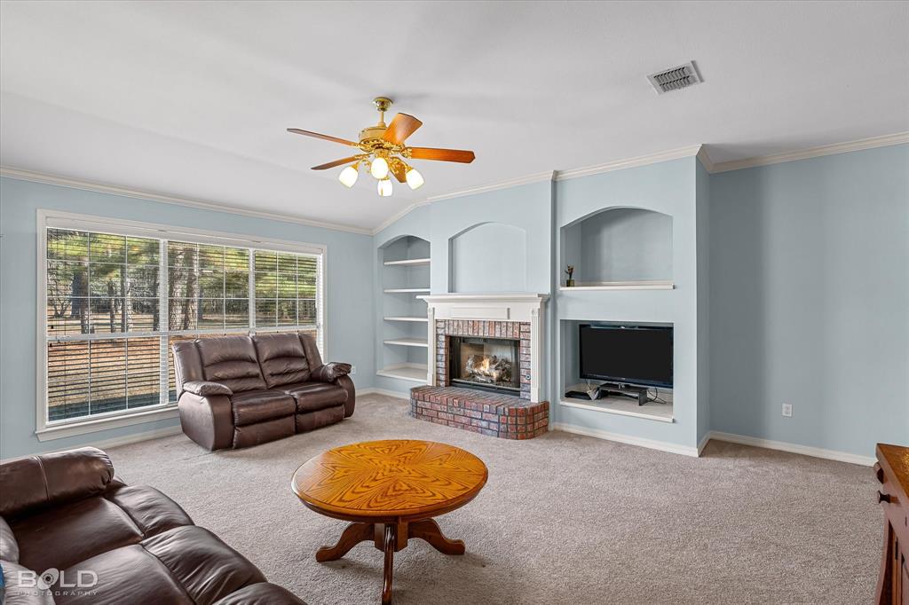 136 Scarborough Road Benton, LA 71006 - Photo 13 of 32 Living area with large windows, light blue walls, and carpet flooring