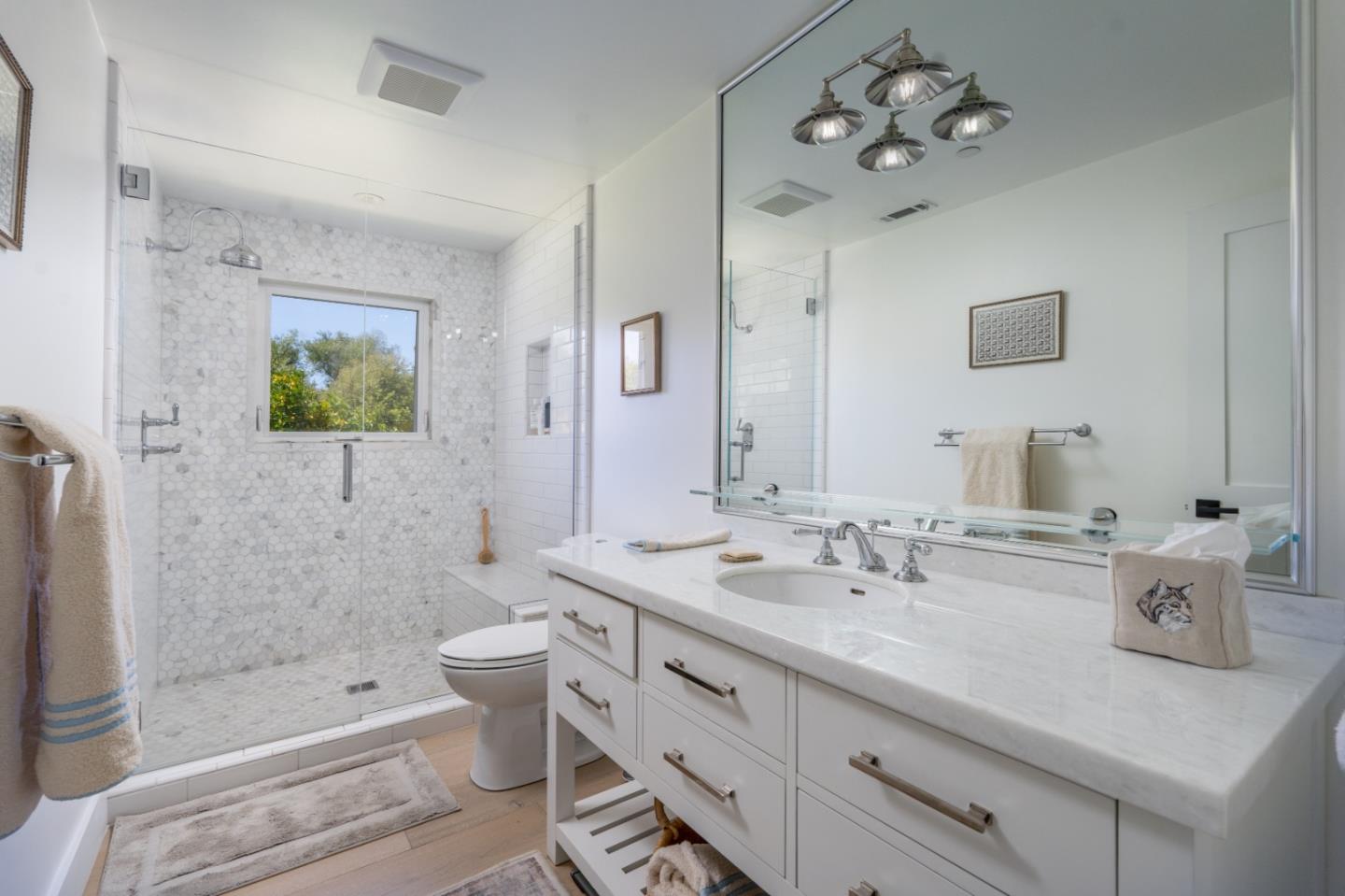 28060 Robinson Canyon Road Carmel, CA 93923 - Photo 19 of 36 a bathroom with a double vanity sink mirror and toilet