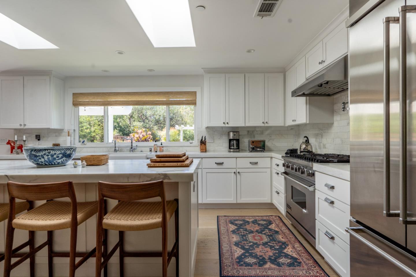 28060 Robinson Canyon Road Carmel, CA 93923 - Photo 22 of 36 a kitchen with stainless steel appliances granite countertop a stove a sink and a refrigerator