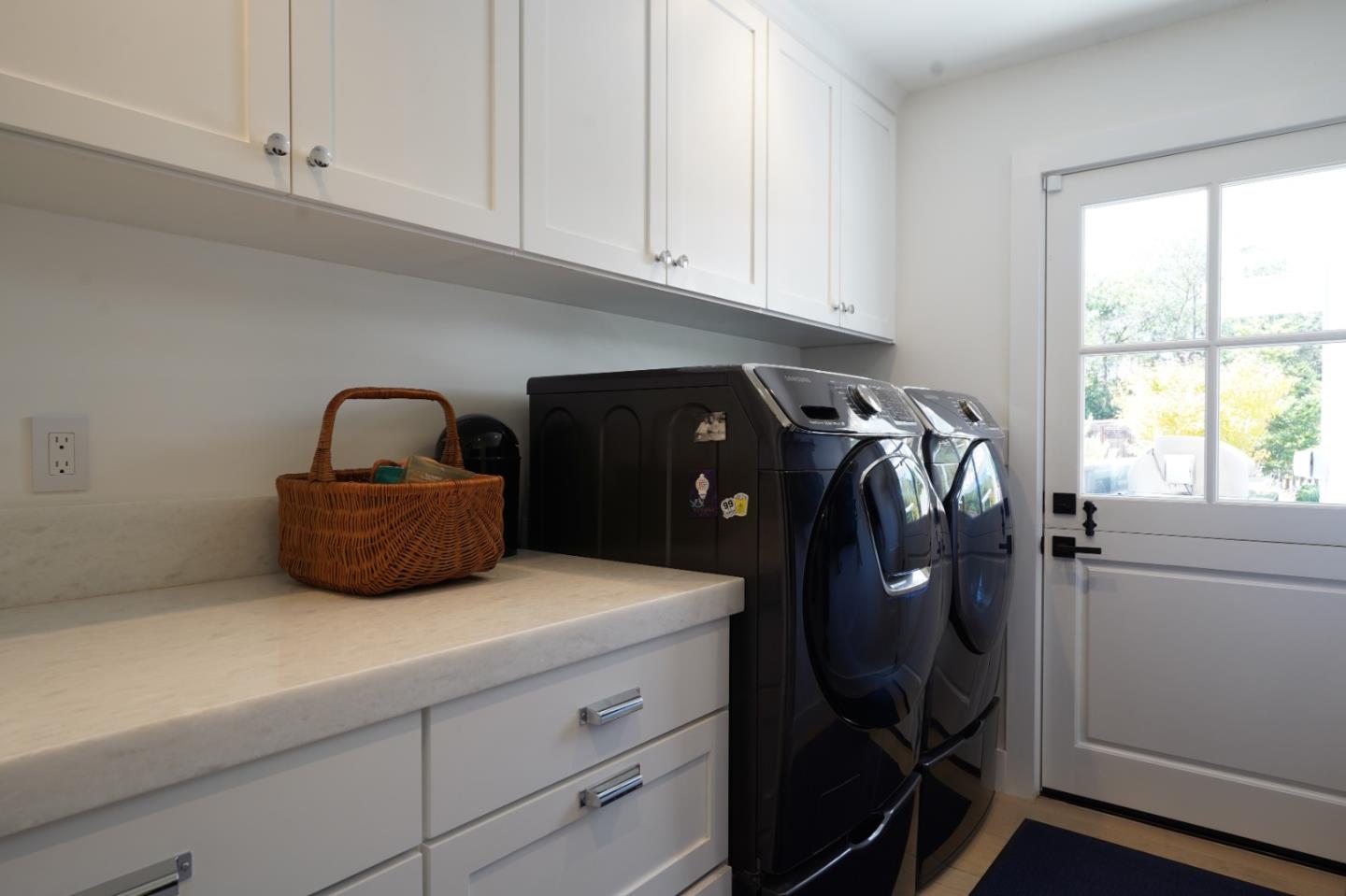 28060 Robinson Canyon Road Carmel, CA 93923 - Photo 24 of 36 a kitchen with a refrigerator and white cabinets
