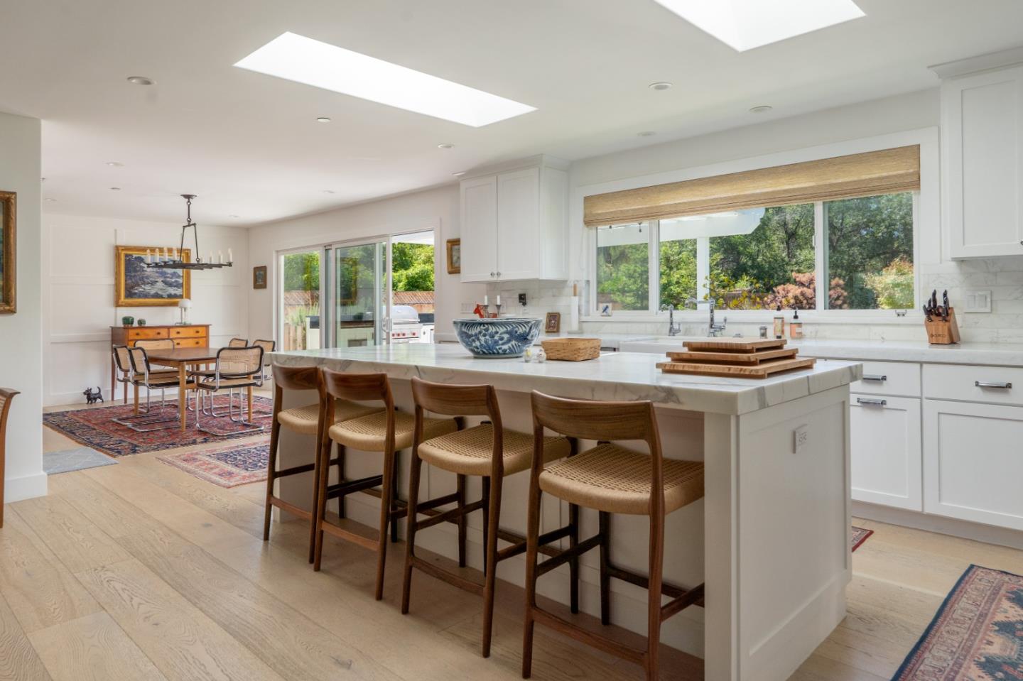 28060 Robinson Canyon Road Carmel, CA 93923 - Photo 8 of 36 a kitchen with a table chairs sink and cabinets