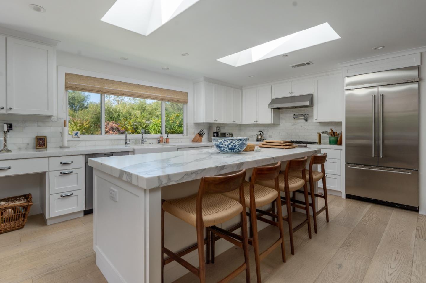 28060 Robinson Canyon Road Carmel, CA 93923 - Photo 9 of 36 a kitchen with a table chairs sink and cabinets