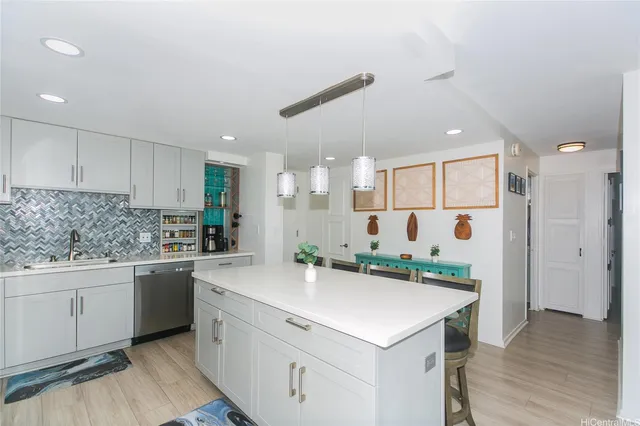 a kitchen with a sink and white cabinets