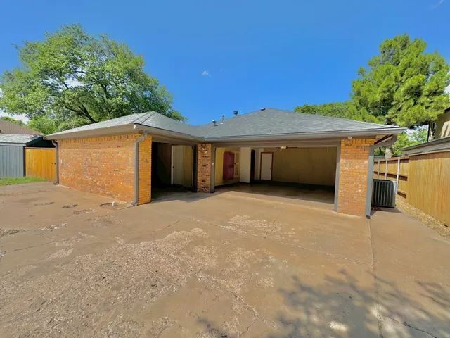 a view of a house with a yard and a garage