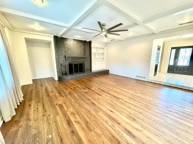 wooden floor in an empty room with a fireplace