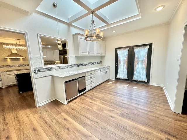 a kitchen with stainless steel appliances granite countertop a stove and a refrigerator