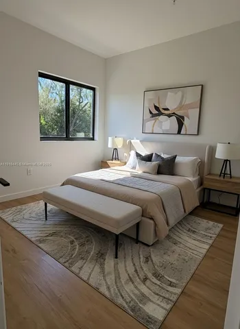 a bedroom with double bed and a window