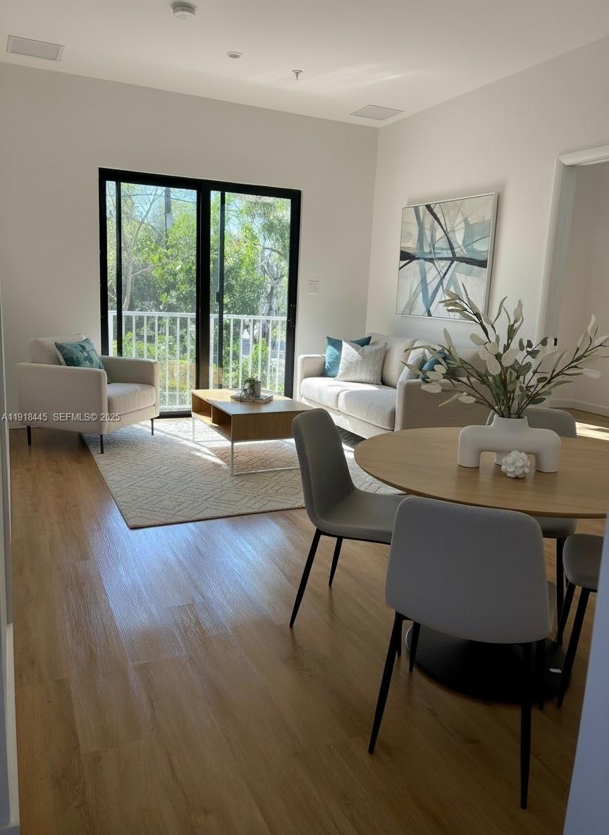 85 Northeast 55th Street, Unit 6 Miami, FL 33137 - Photo 6 of 15 a living room with furniture and a large window