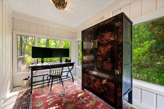 a living room with a flat screen tv and a floor to ceiling window