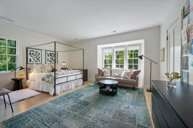 a spacious bathroom with a double vanity sink a large mirror and a bathtub