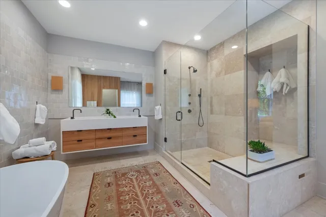 a bedroom with furniture a fireplace and a flat screen tv