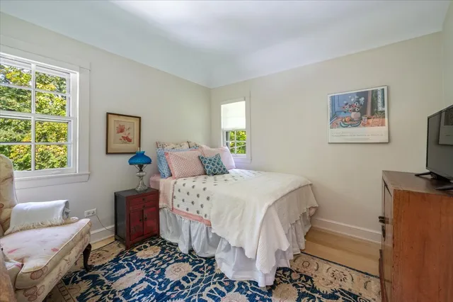 a roof deck with table and chairs and potted plants