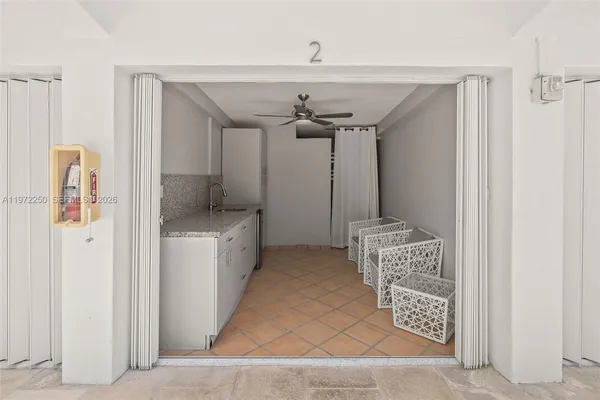 a spacious bathroom with a granite countertop sink and a mirror
