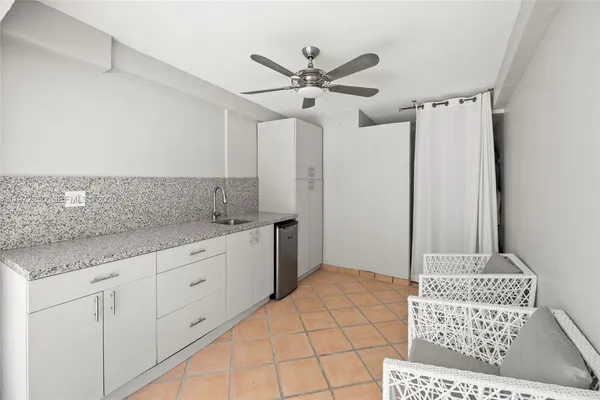 a room with a sink a rug and a chair