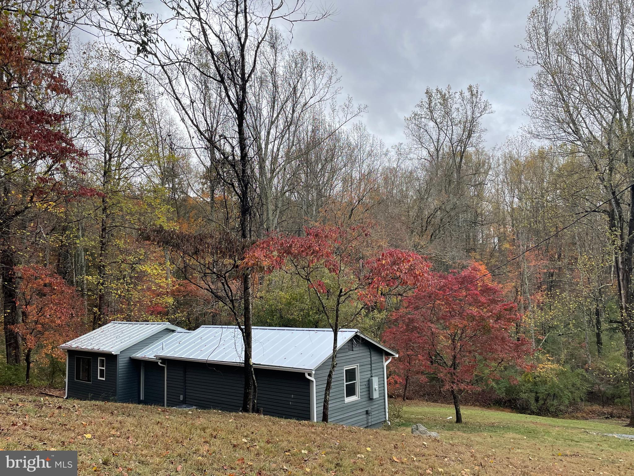 240 Whorton Hollow Road Castleton, VA 22716 - Photo 18 of 37 a view of a house with a yard