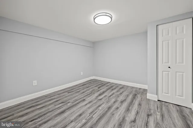 a view of a room with wooden floor and white walls