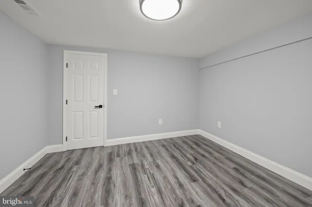 a view of room with wooden floor