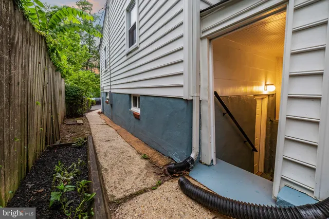 a view of a balcony with chair and wooden door