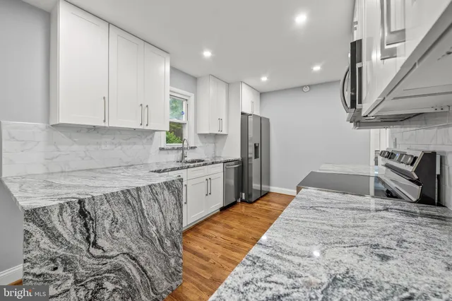 a kitchen with refrigerator and cabinets