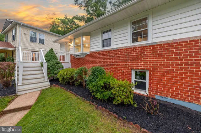 a view of a house with a yard and furniture