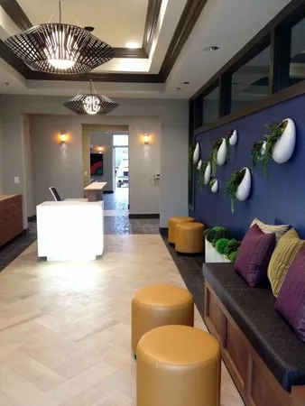 a living room with furniture and a chandelier