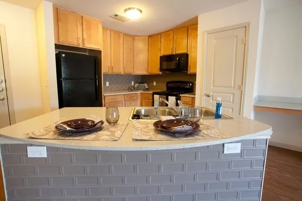 a kitchen with a sink stove and microwave