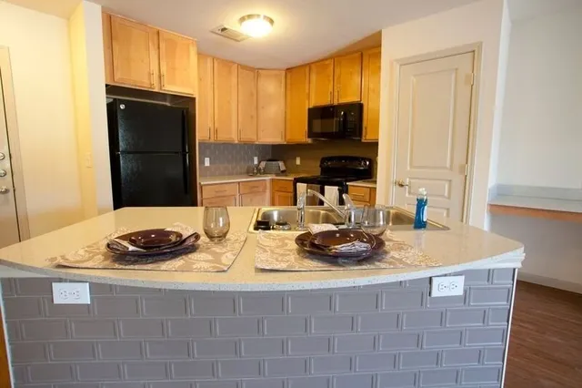 a kitchen with a sink stove and microwave