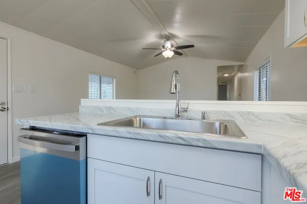 a kitchen with a sink and a mirror