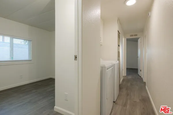 a view of a hallway with wooden floor