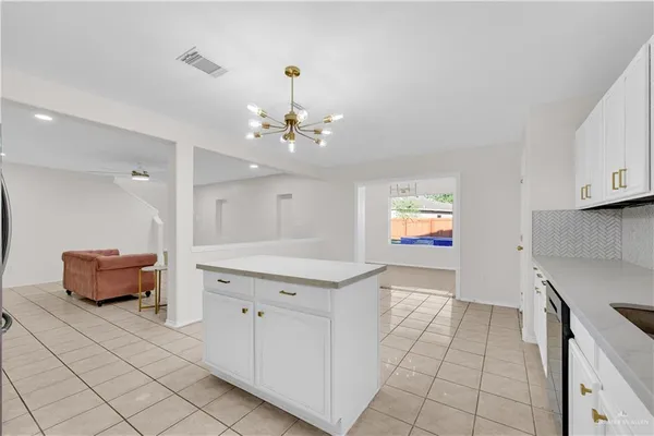 a kitchen with stainless steel appliances granite countertop a sink and cabinets