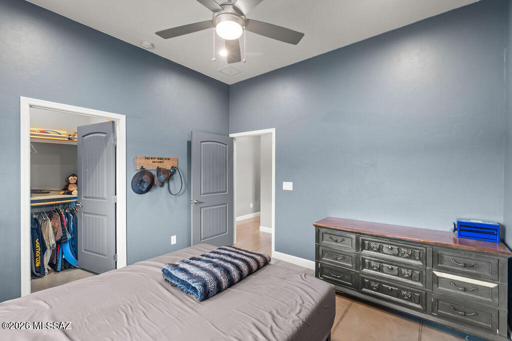 16276 East Empire View Road Vail, AZ 85641 - Photo 29 of 51 a bedroom with a bed and a chandelier