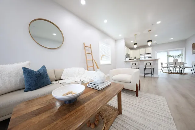 a living room with furniture and wooden floor