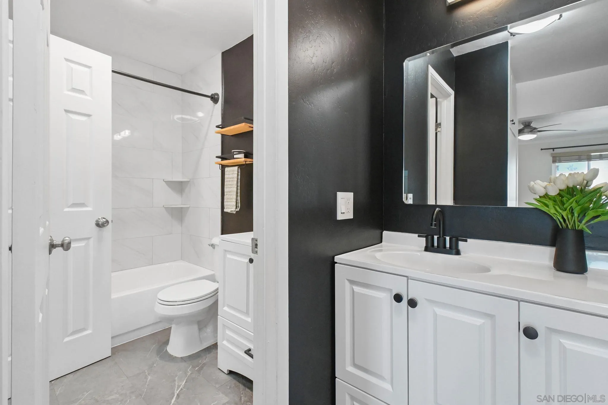 3550 Ruffin Road, Unit 235 San Diego, CA 92123 - Photo 16 of 26 a bathroom with a sink toilet and shower