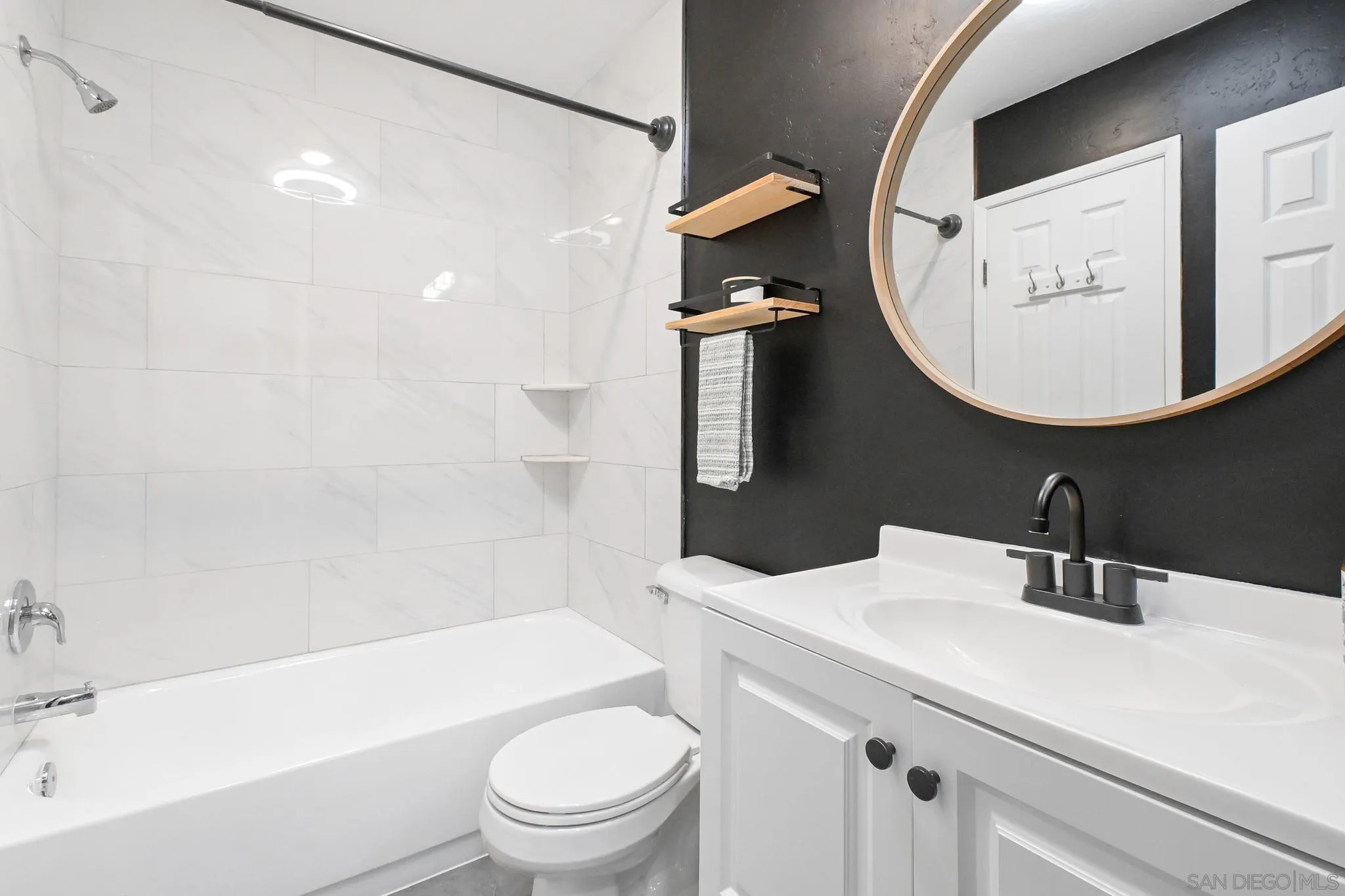 3550 Ruffin Road, Unit 235 San Diego, CA 92123 - Photo 17 of 26 a bathroom with a sink a toilet and a mirror
