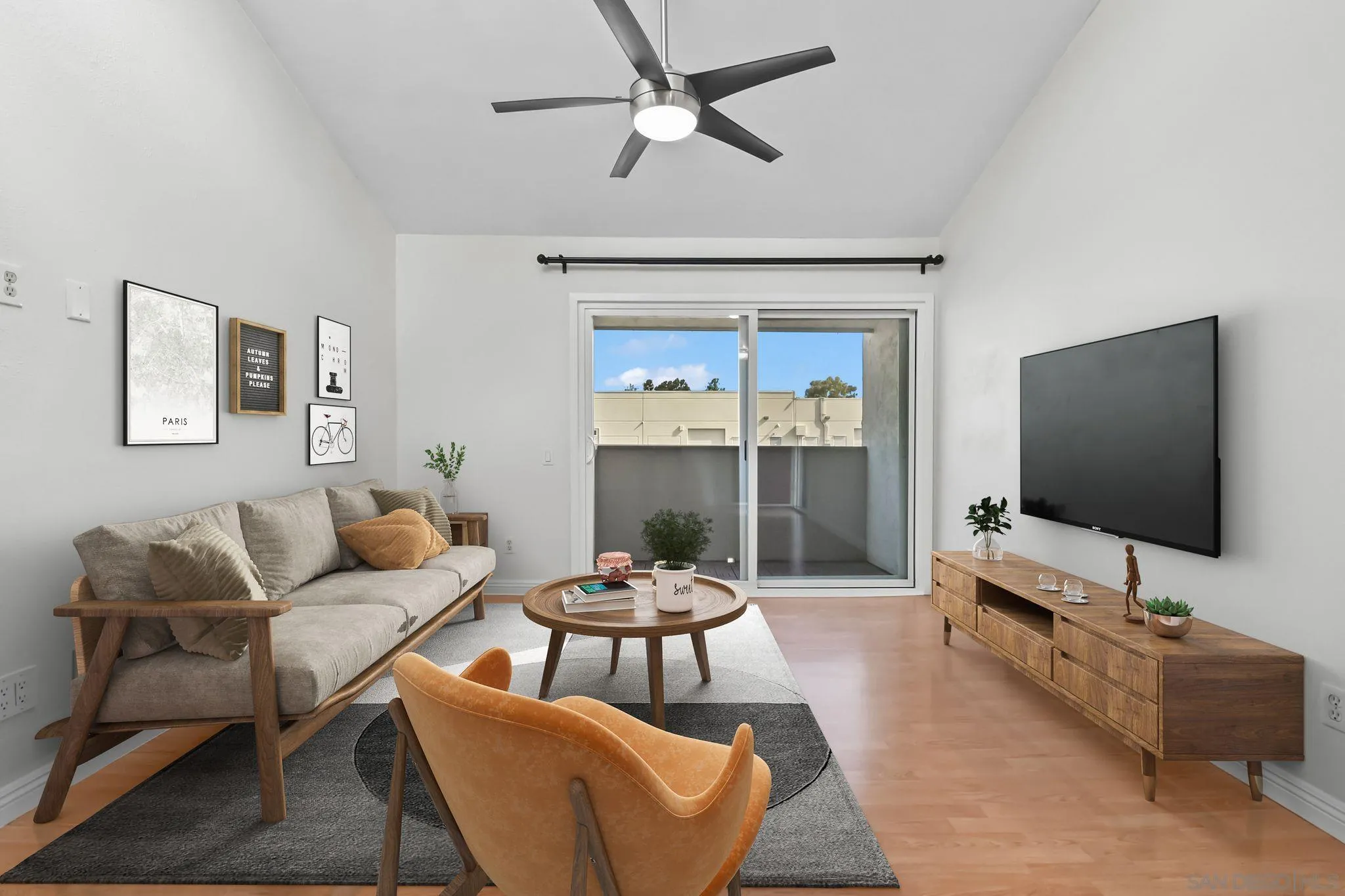 3550 Ruffin Road, Unit 235 San Diego, CA 92123 - Photo 3 of 26 a living room with furniture and a flat screen tv