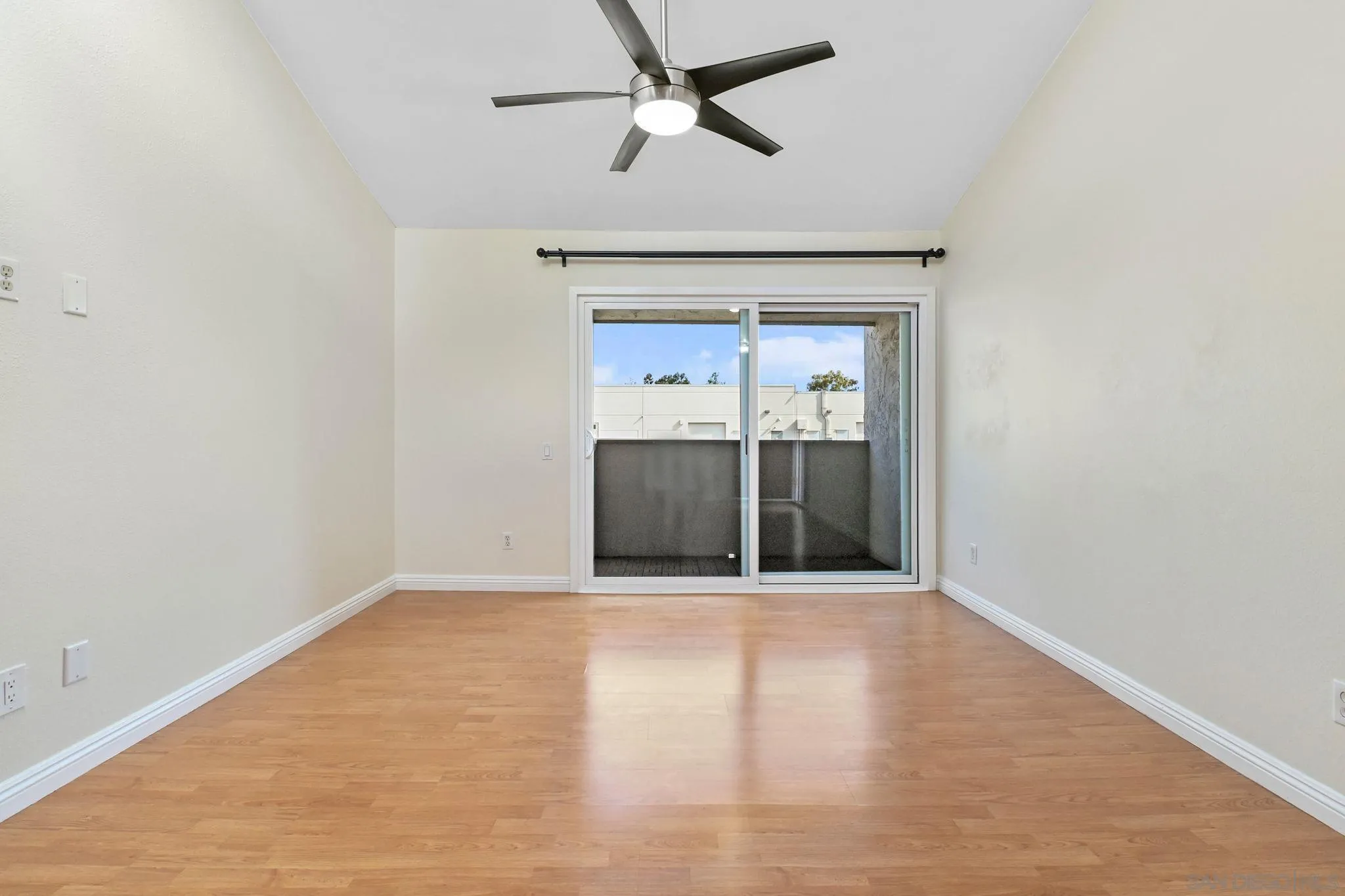 3550 Ruffin Road, Unit 235 San Diego, CA 92123 - Photo 4 of 26 a view of an empty room with wooden floor and a ceiling fan