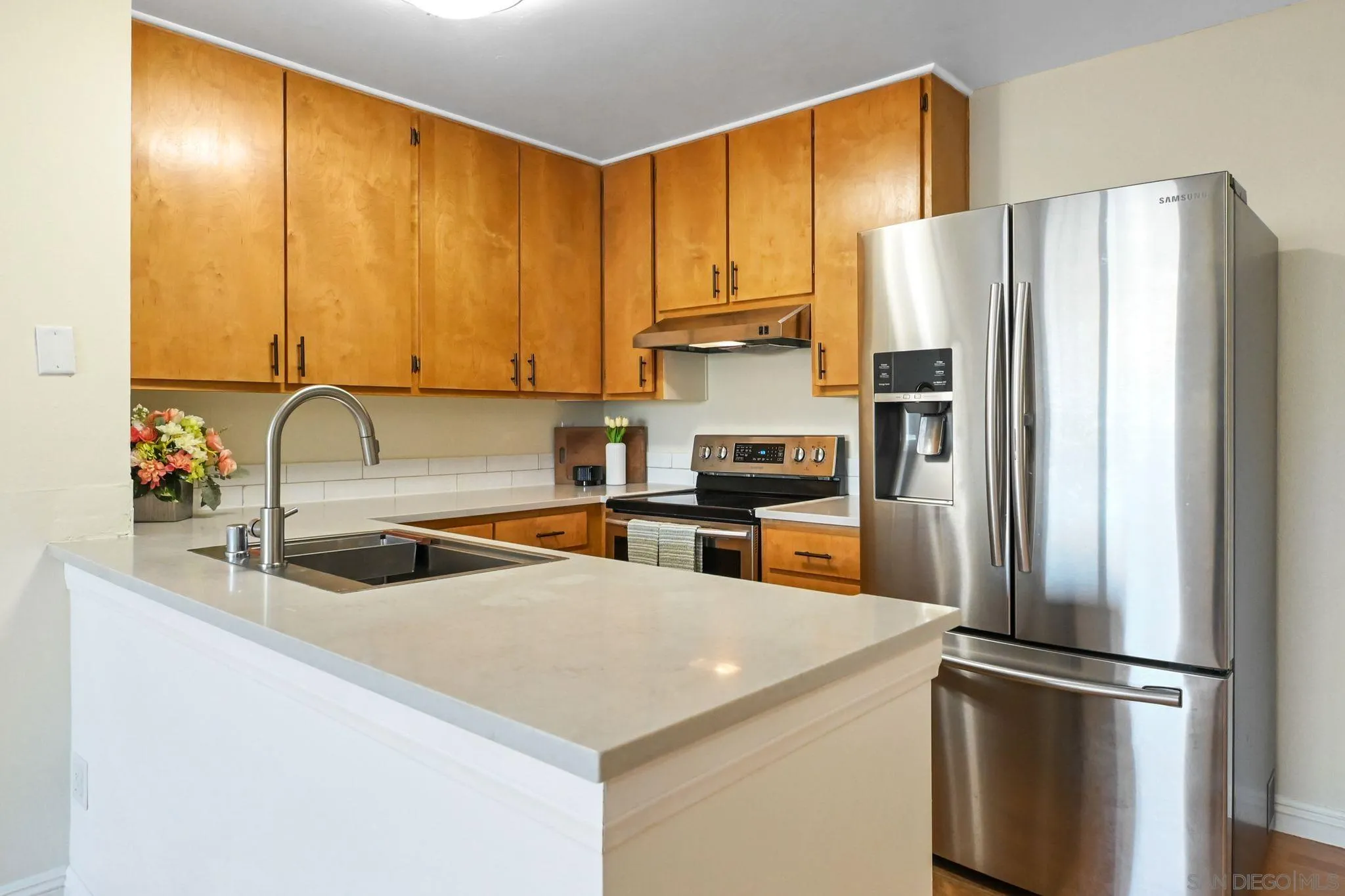3550 Ruffin Road, Unit 235 San Diego, CA 92123 - Photo 9 of 26 a kitchen with stainless steel appliances granite countertop a refrigerator a sink and a stove