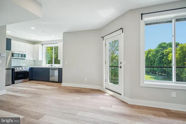 a view of kitchen with wooden floor and window