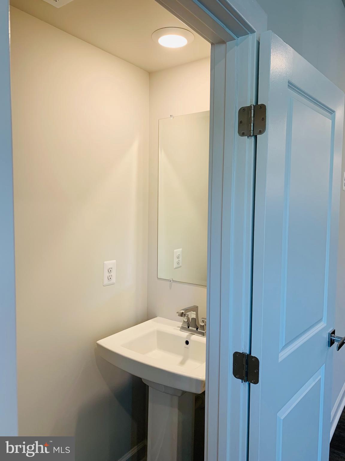 12884 Sunrise Ridge Alley, Unit 47 Herndon, VA 20171 - Photo 12 of 37 a bathroom with a sink and mirror