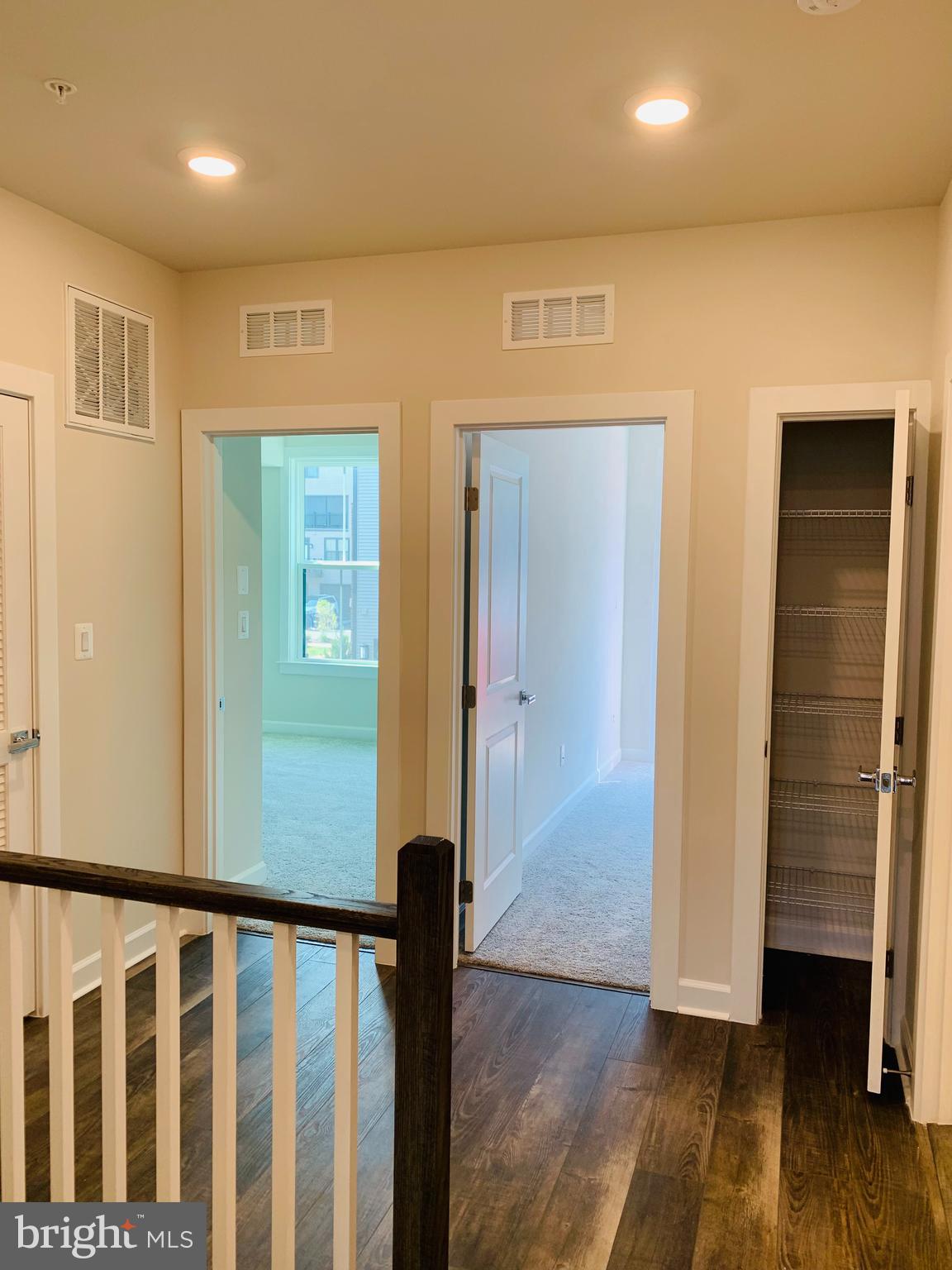 12884 Sunrise Ridge Alley, Unit 47 Herndon, VA 20171 - Photo 15 of 37 a view of a hallway with wooden floor and entryway
