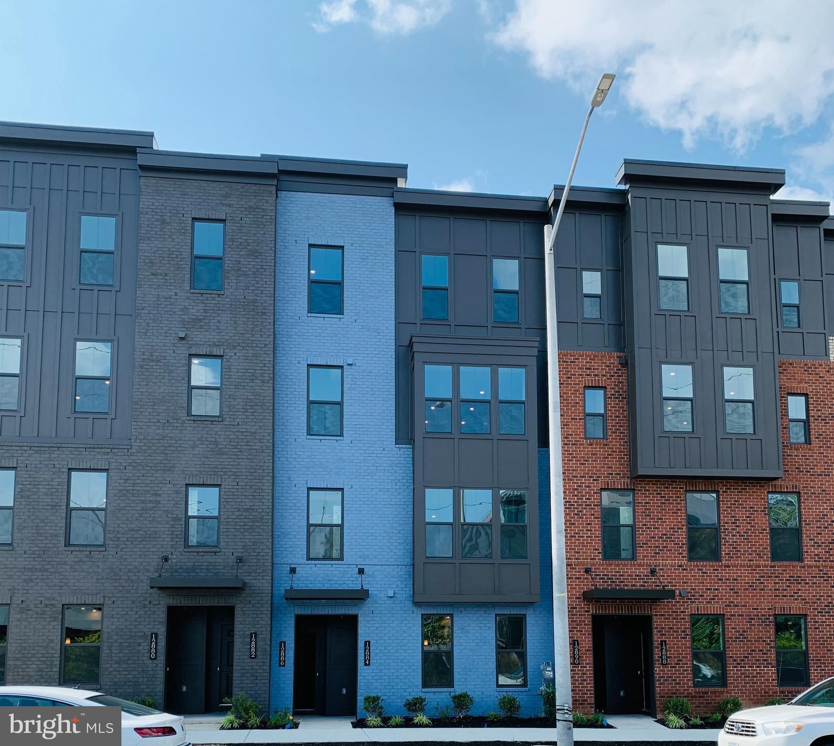 12884 Sunrise Ridge Alley, Unit 47 Herndon, VA 20171 - Photo 2 of 37 a front view of a building with glass windows