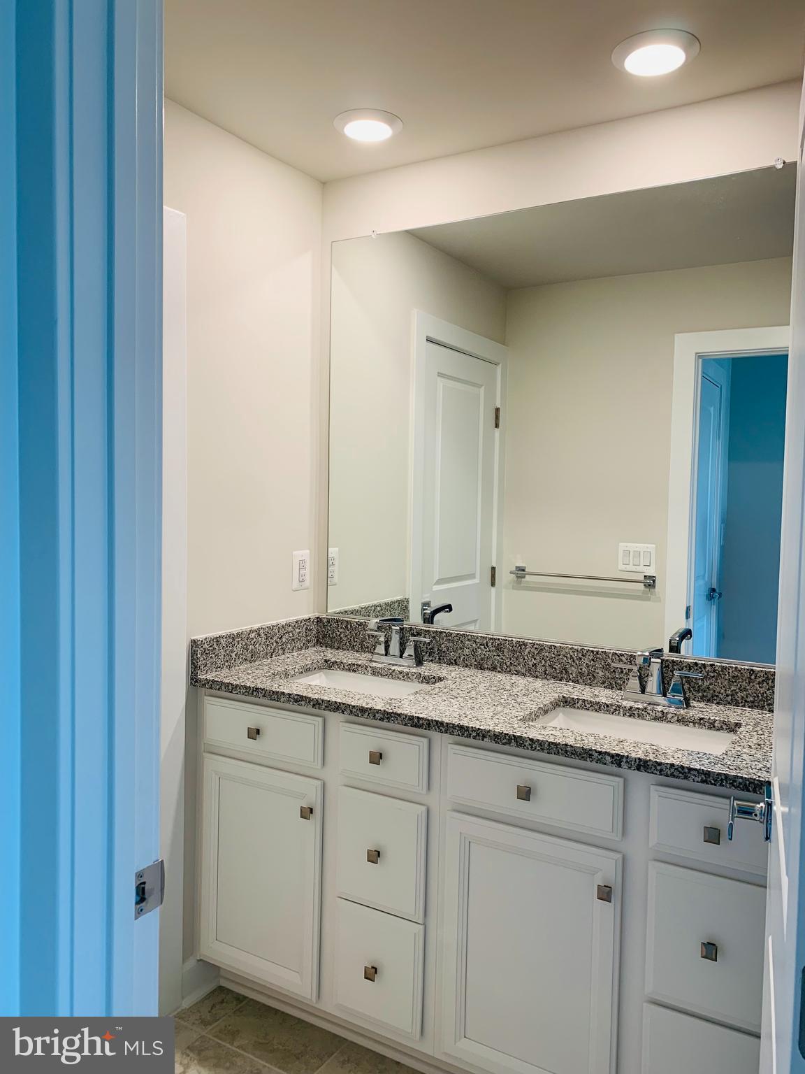 12884 Sunrise Ridge Alley, Unit 47 Herndon, VA 20171 - Photo 21 of 37 a bathroom with a granite countertop sink and white cabinets