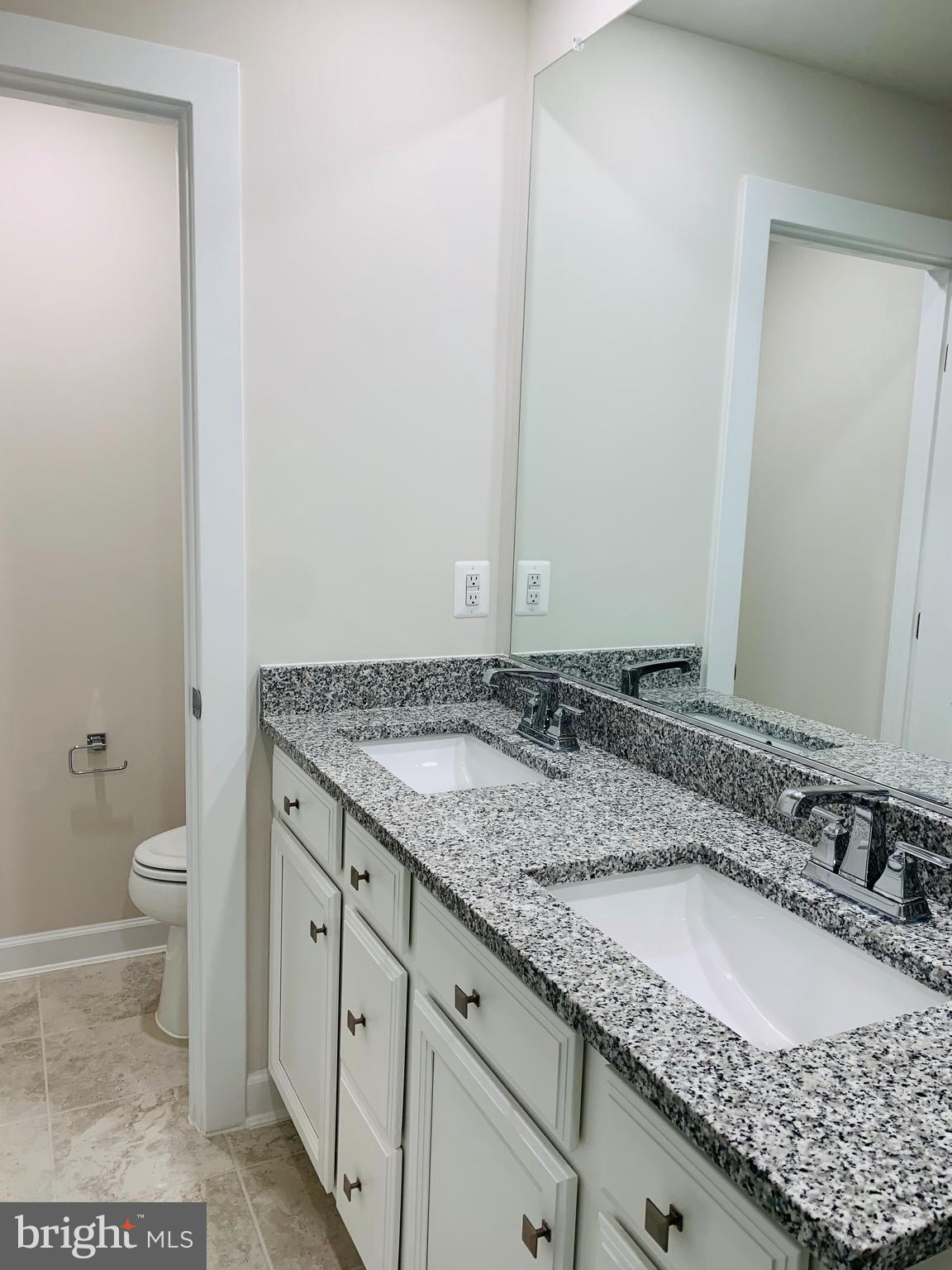 12884 Sunrise Ridge Alley, Unit 47 Herndon, VA 20171 - Photo 22 of 37 a bathroom with a granite countertop sink and a mirror
