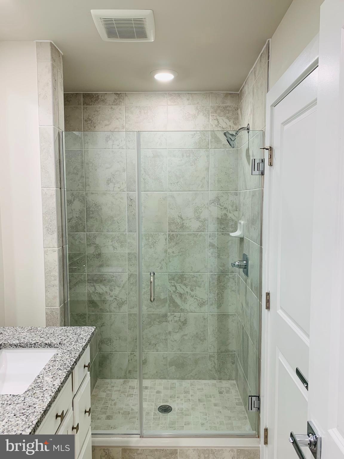 12884 Sunrise Ridge Alley, Unit 47 Herndon, VA 20171 - Photo 23 of 37 a bathroom with a shower and a sink
