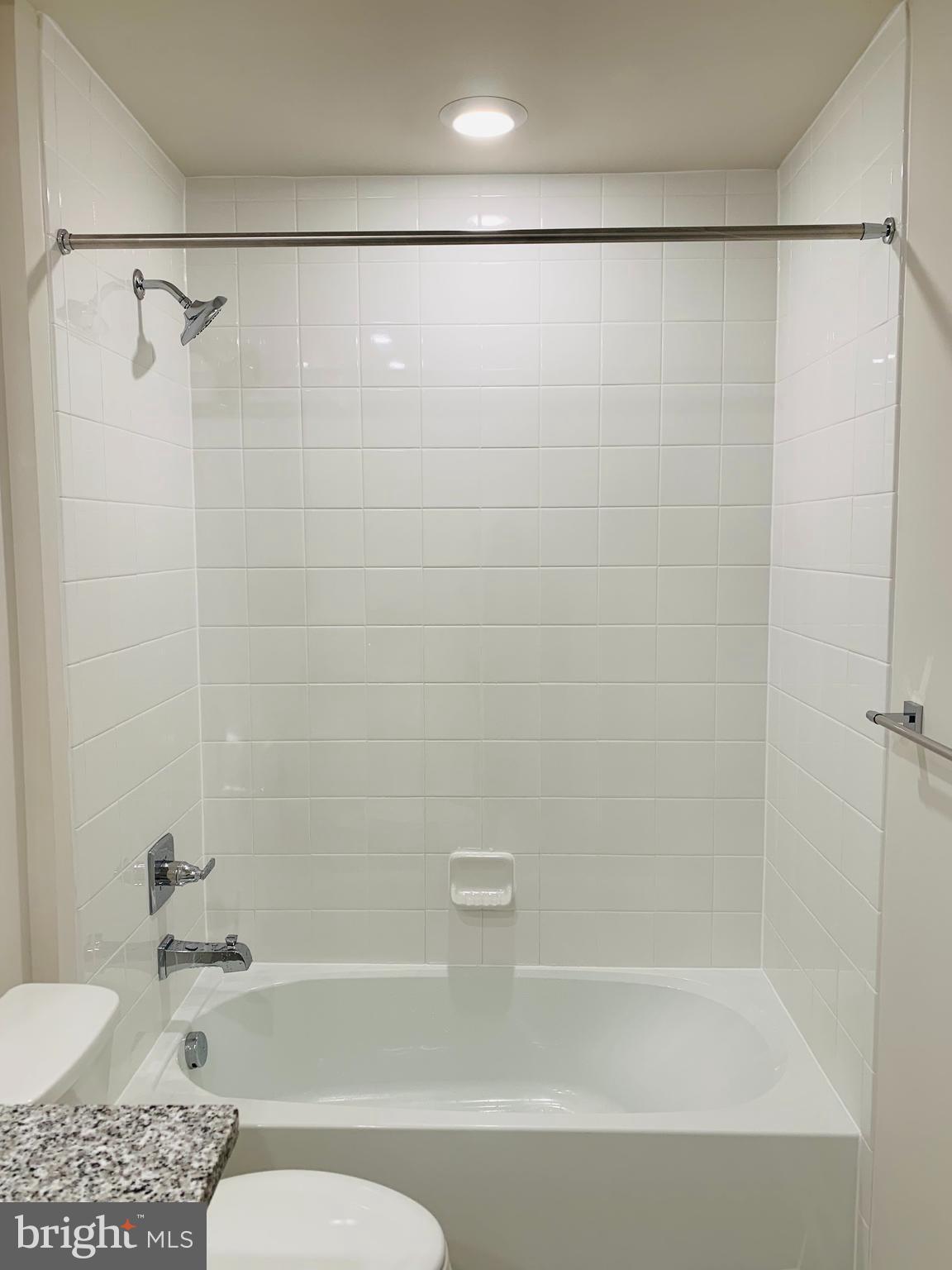 12884 Sunrise Ridge Alley, Unit 47 Herndon, VA 20171 - Photo 29 of 37 a bathroom with a bathtub and a shower